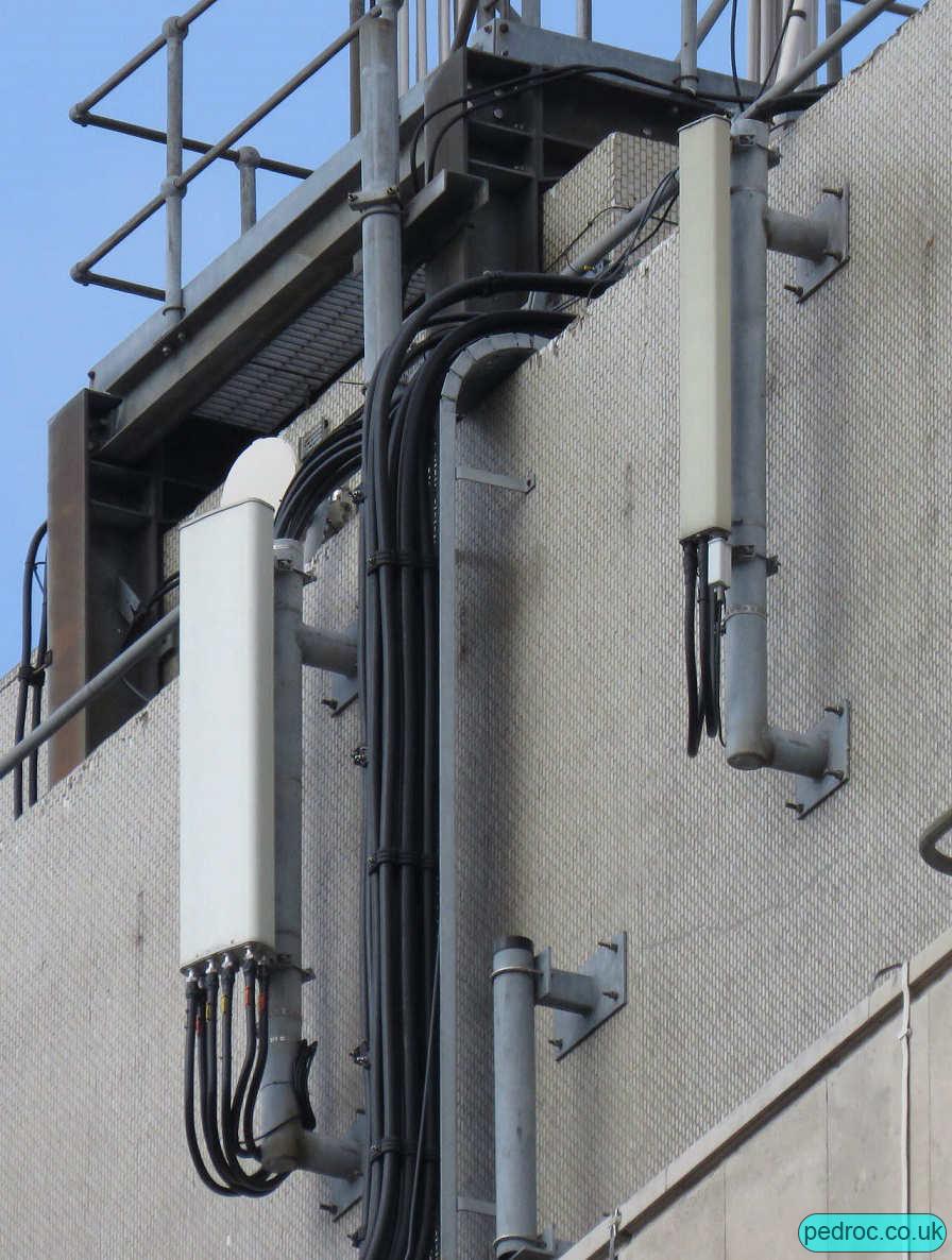 Closeup of antennas of EE and 3 Mast on Kingston House, Hull.